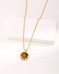 Hand-carved tiger's eye stone pendant with volcanic lava texture